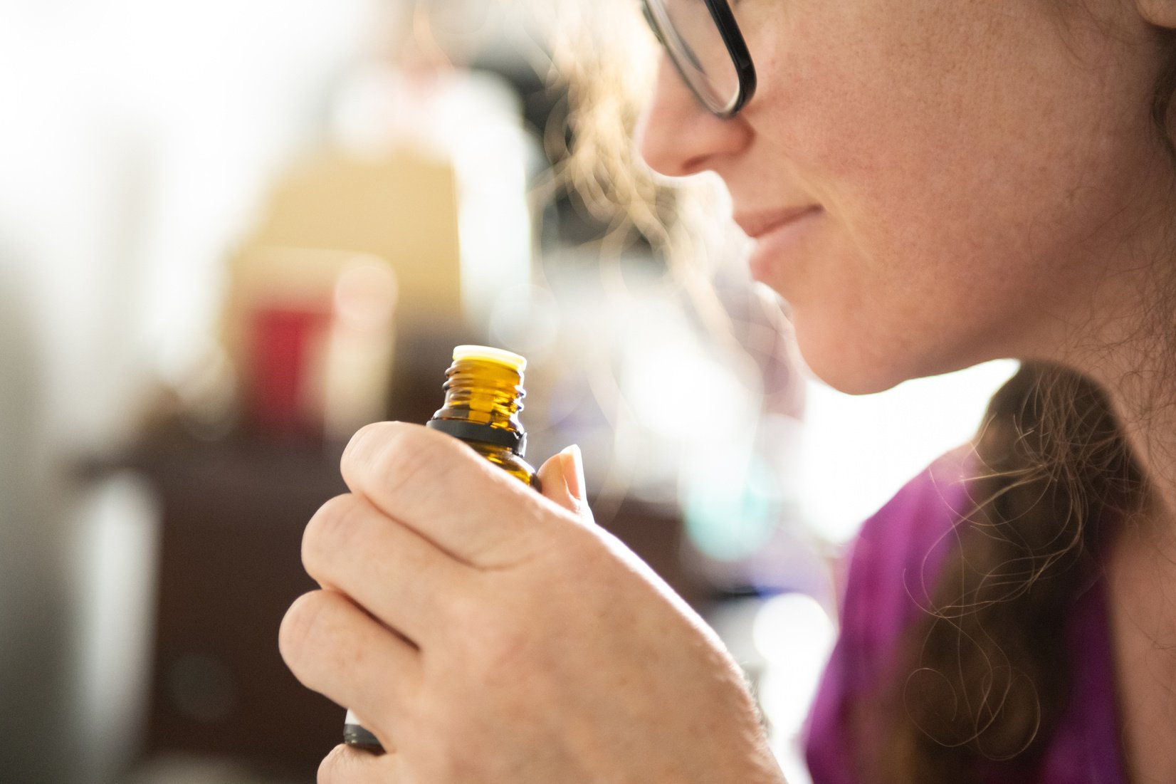 Woman Smells Aromatherapy Essential Oil in the Morning During Lockdown